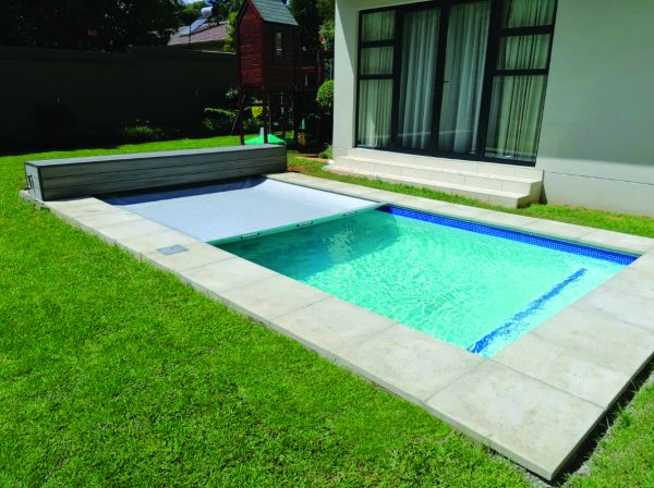 designer pool covers A small backyard pool with an Easy Glide Safety Cover.